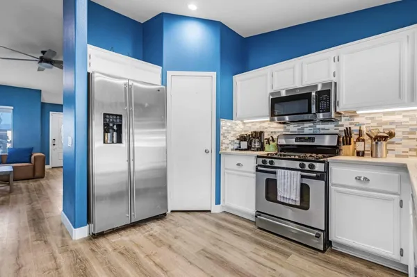 a kitchen with a stove a sink and a refrigerator