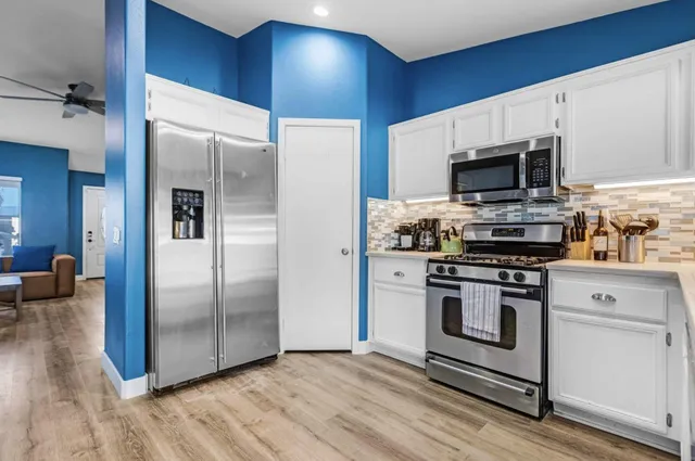 a kitchen with a stove a sink and a refrigerator