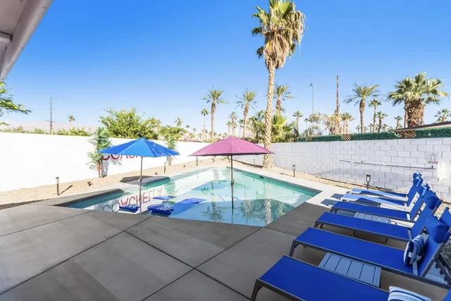 swimming pool view with a seating space
