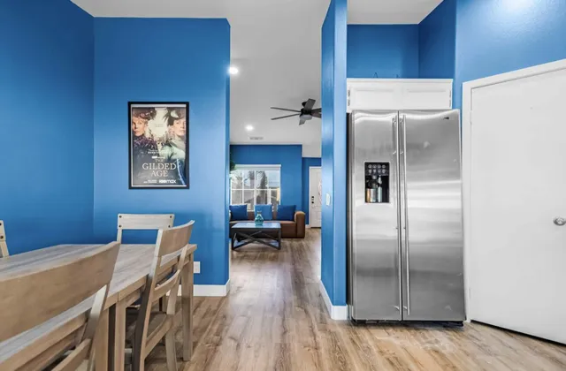 a view of a dining room with furniture and wooden floor