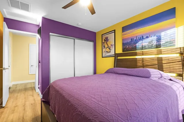 a bedroom with bed and wooden floor