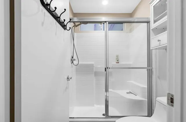 a bathroom with a sink toilet and shower