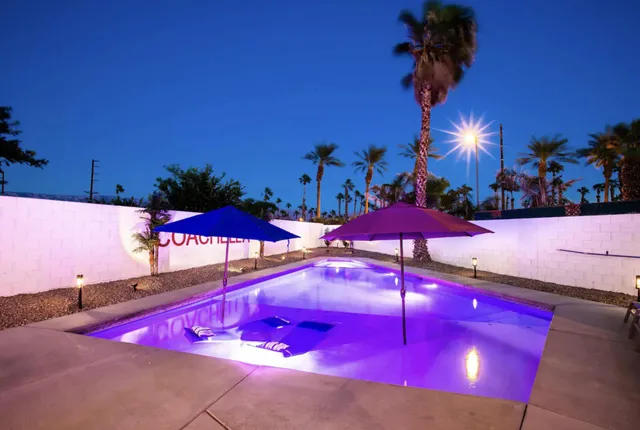 an outdoor space with pool and furniture