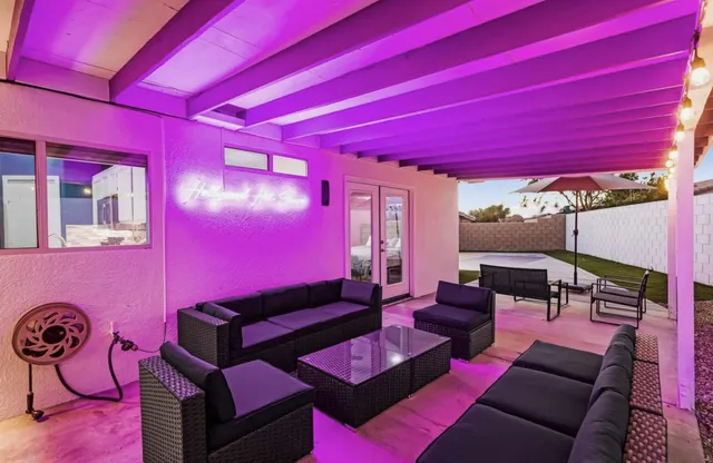 a living room with furniture a rug and a floor to ceiling window