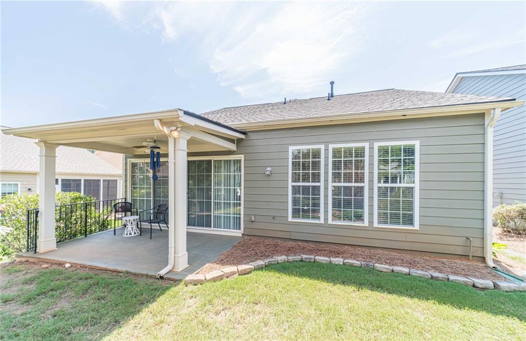 6260 Brookside Lane Hoschton, GA 30548 - Photo 14 of 59 a front view of a house with garden