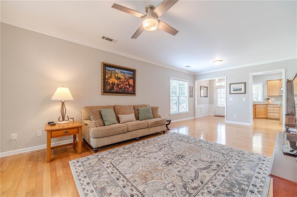 6260 Brookside Lane Hoschton, GA 30548 - Photo 20 of 59 a living room with furniture and a wooden floor