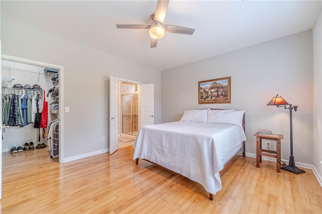 6260 Brookside Lane Hoschton, GA 30548 - Photo 25 of 59 a bedroom with a bed and a chandelier