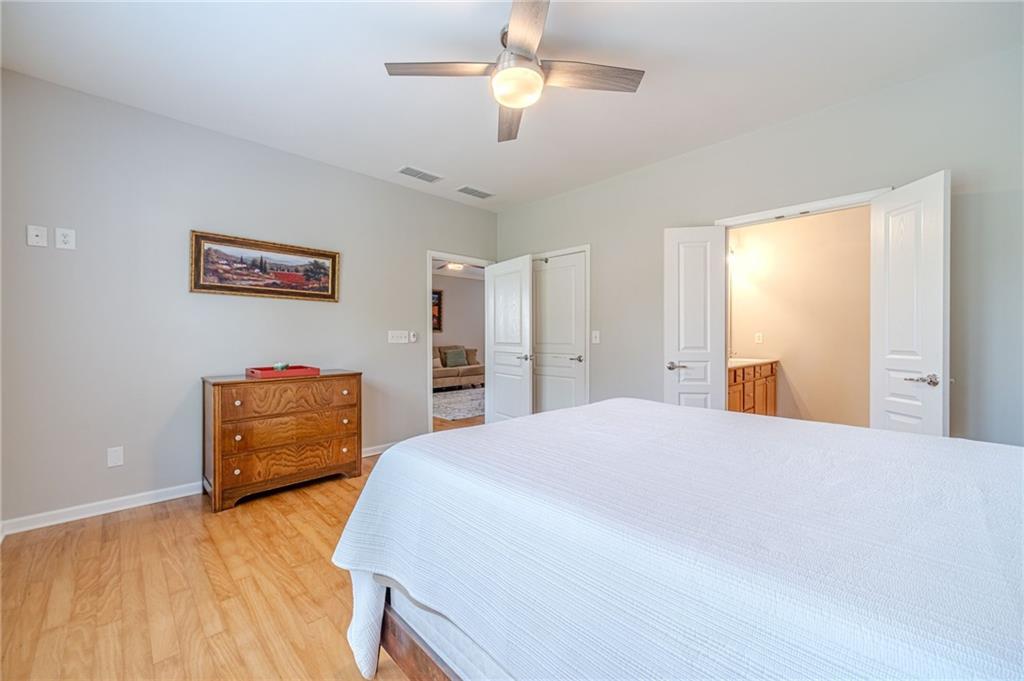 6260 Brookside Lane Hoschton, GA 30548 - Photo 26 of 59 a bedroom with a bed and a dresser