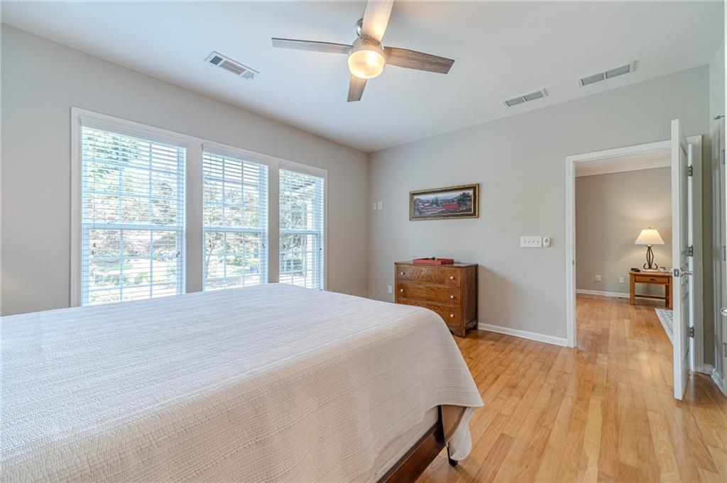 6260 Brookside Lane Hoschton, GA 30548 - Photo 27 of 59 a bedroom with a bed and a chandelier