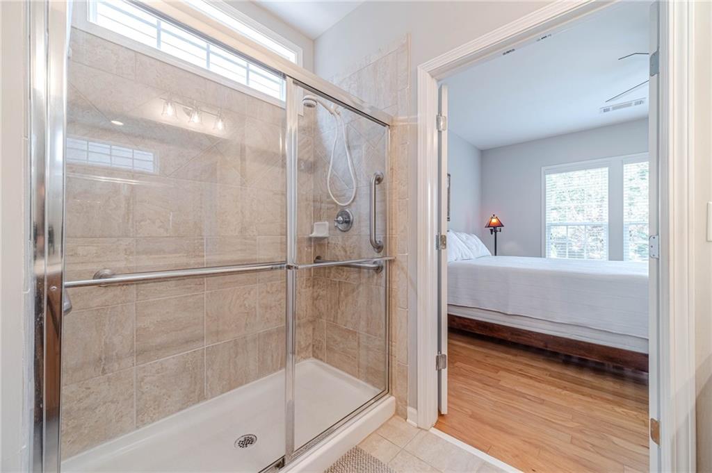 6260 Brookside Lane Hoschton, GA 30548 - Photo 31 of 59 a bathroom with a bathtub and a shower