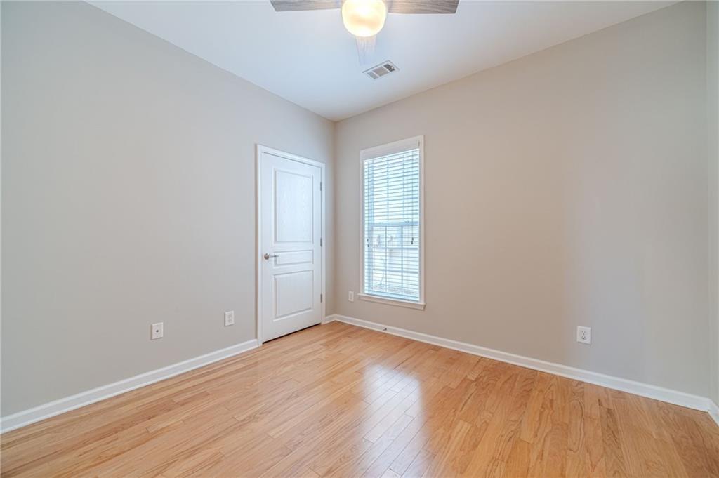 6260 Brookside Lane Hoschton, GA 30548 - Photo 32 of 59 an empty room with wooden floor and windows