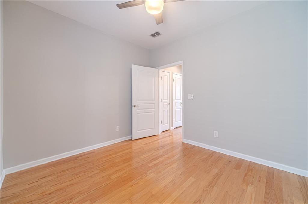 6260 Brookside Lane Hoschton, GA 30548 - Photo 35 of 59 a view of an empty room with wooden floor and a window