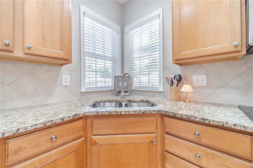 6260 Brookside Lane Hoschton, GA 30548 - Photo 42 of 59 a kitchen with granite countertop cabinets and window