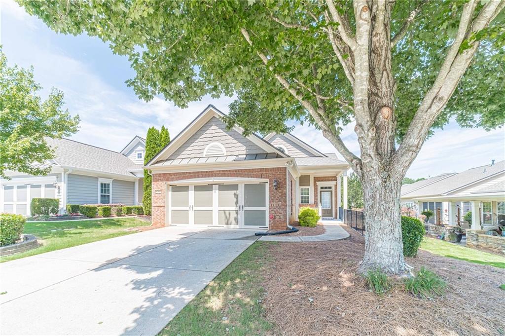 6260 Brookside Lane Hoschton, GA 30548 - Photo 7 of 59 a view of a house with a yard and large trees