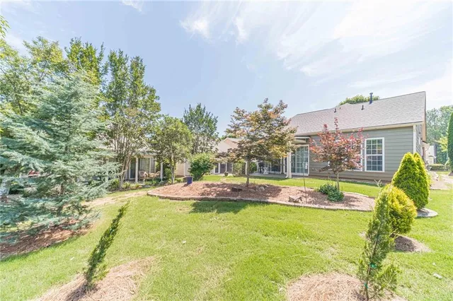 a view of a house with swimming pool and a yard
