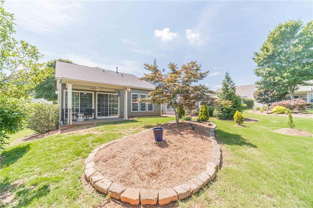 6260 Brookside Lane Hoschton, GA 30548 - Photo 10 of 59 a view of a house with swimming pool and a yard