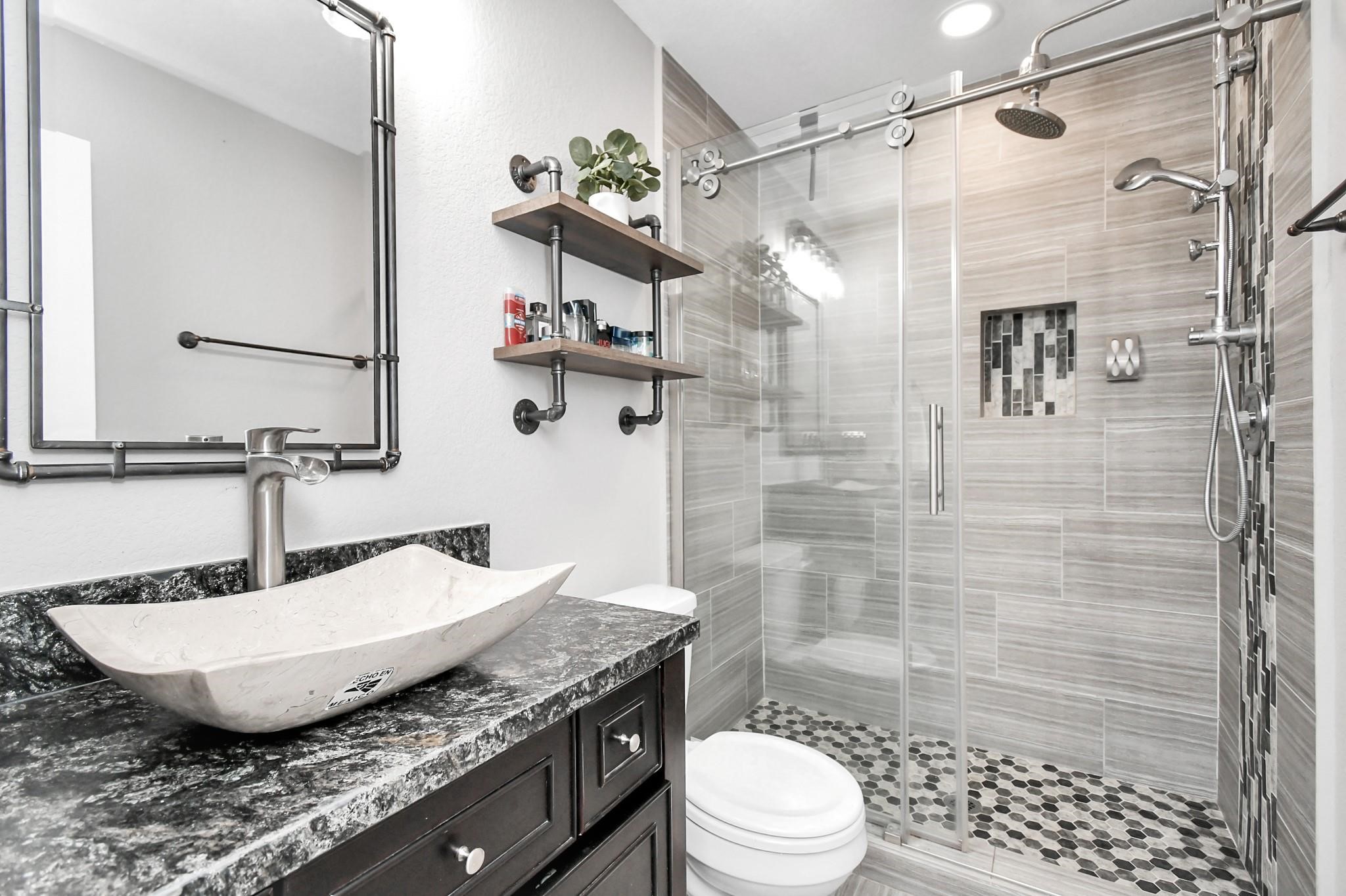 23507 Tree House Lane Spring, TX 77373 - Photo 11 of 17 a bathroom with a granite countertop sink a toilet and shower
