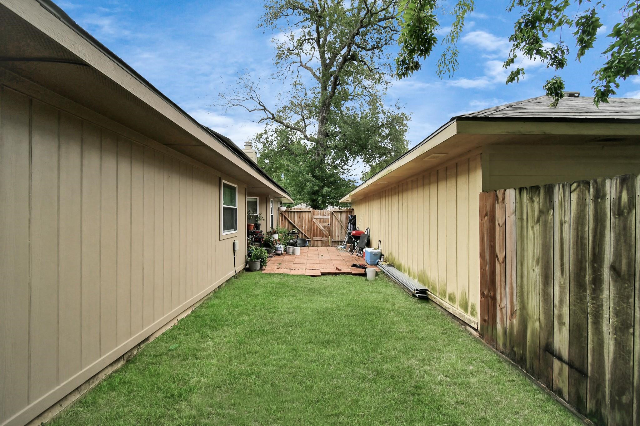 23507 Tree House Lane Spring, TX 77373 - Photo 13 of 17 a view of a backyard with couches under an umbrella