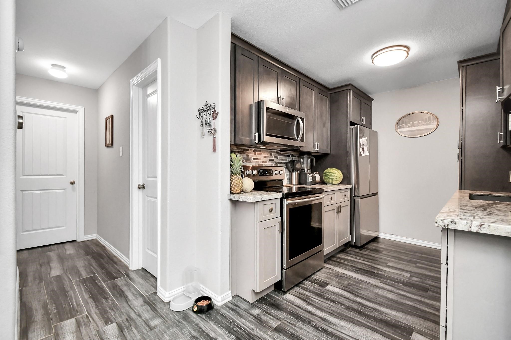 23507 Tree House Lane Spring, TX 77373 - Photo 5 of 17 a kitchen with stainless steel appliances a refrigerator stove and sink