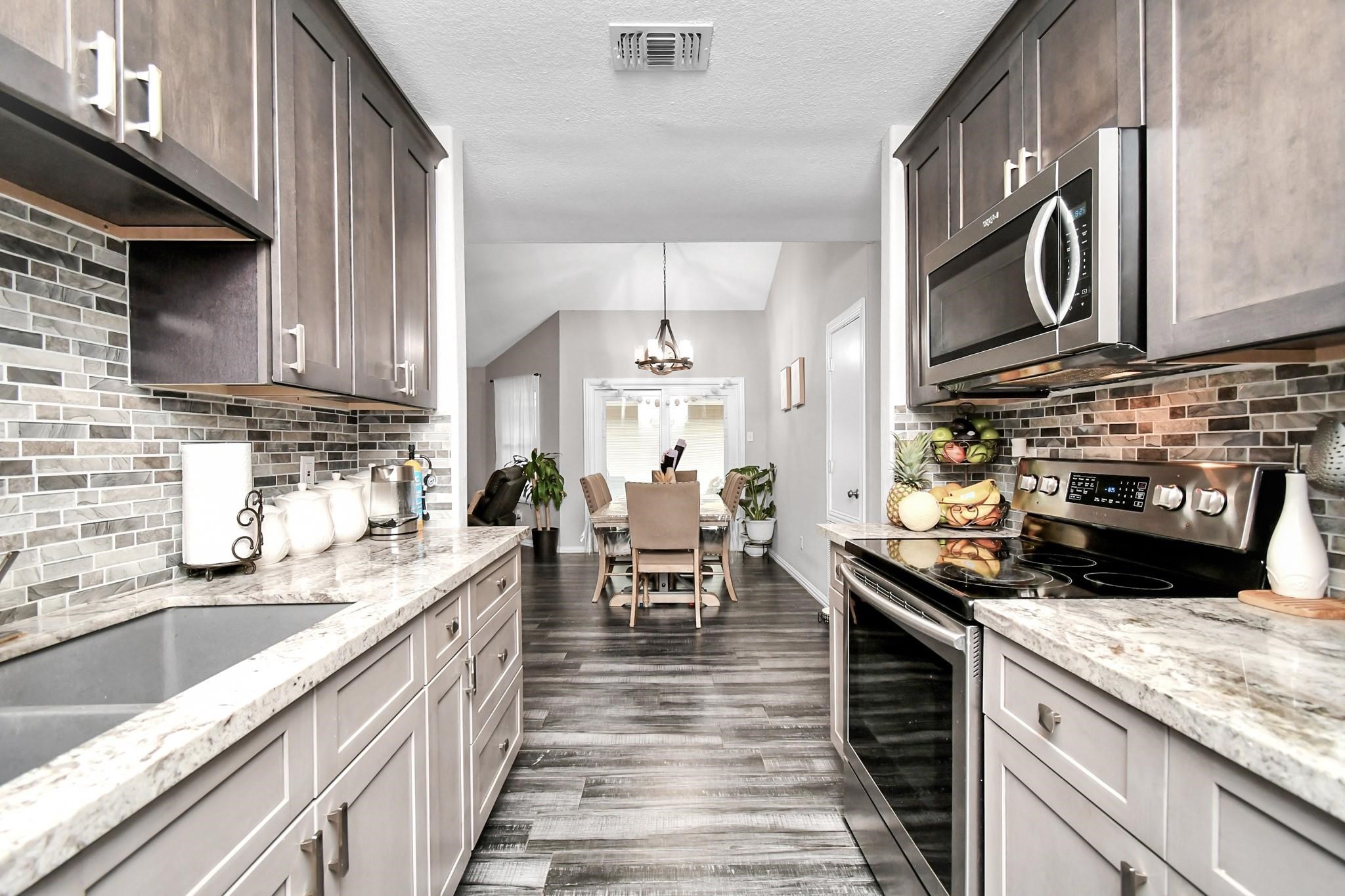 23507 Tree House Lane Spring, TX 77373 - Photo 6 of 17 a kitchen with granite countertop lots of counter top space