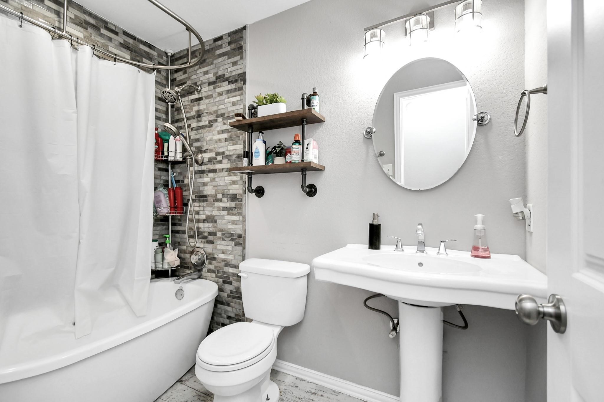 23507 Tree House Lane Spring, TX 77373 - Photo 10 of 17 a bathroom with a sink toilet and shower