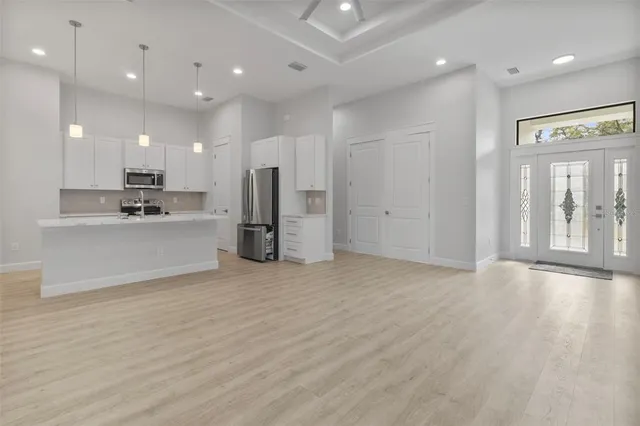 a view of a kitchen with a refrigerator and a sink