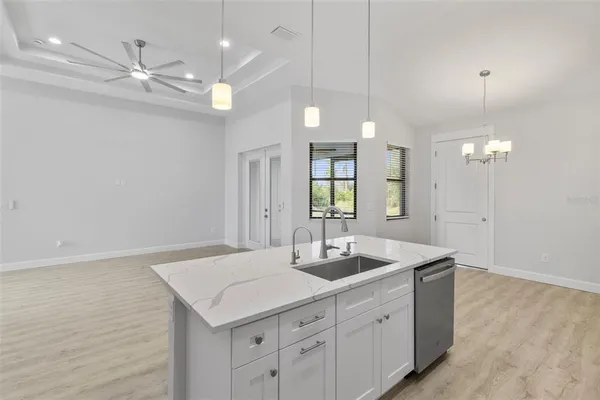 a bathroom with a sink a light fixture and a mirror