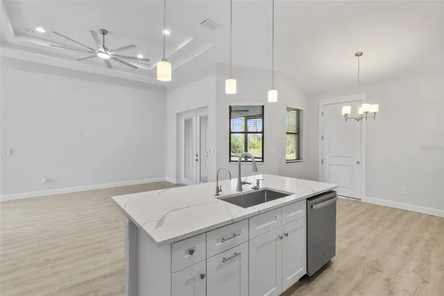 a bathroom with a sink a light fixture and a mirror