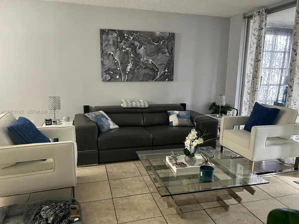 a living room with furniture and a large window