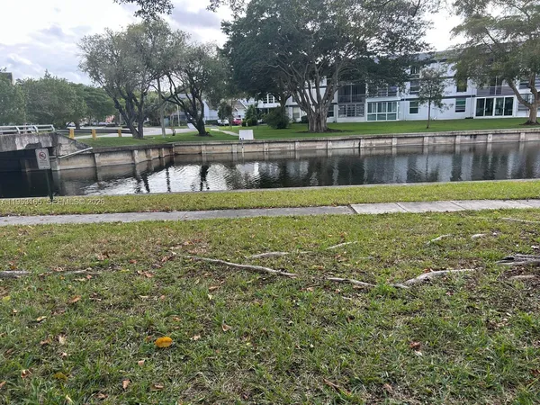 a view of a yard with a house in the background