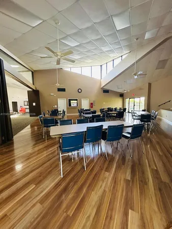a living room with lots of furniture and view of kitchen