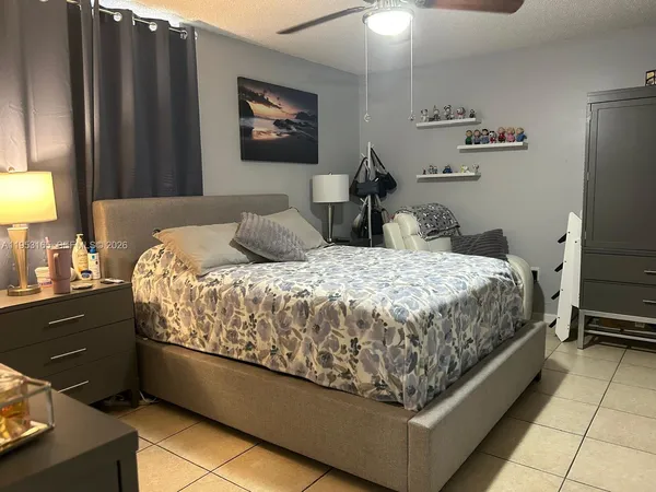 a bedroom with a bed dresser and a window