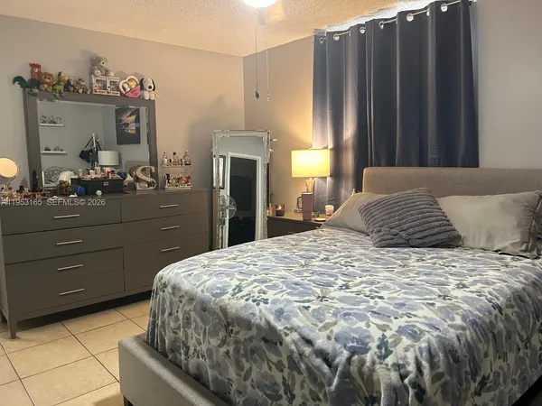 a bedroom with a bed and a mirror