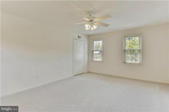 15507 Good Hope Road Silver Spring, MD 20905 - Photo 14 of 30 an empty room with windows and chandelier fan