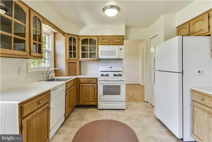 15507 Good Hope Road Silver Spring, MD 20905 - Photo 3 of 30 a kitchen with a white stove top oven and refrigerator