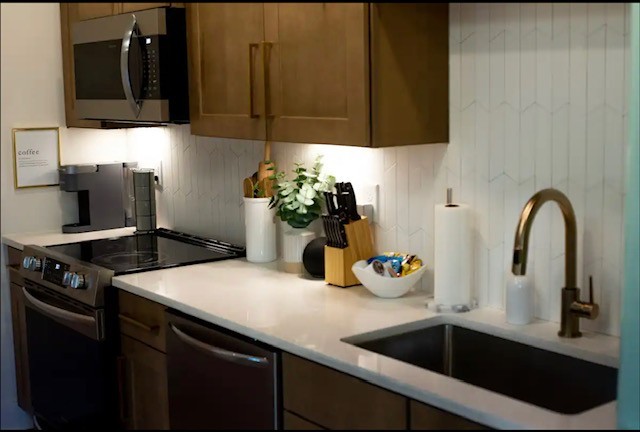 1701 Porter Road, Unit 8 Nashville, TN 37206 - Photo 3 of 17 a kitchen with a sink and a potted plant