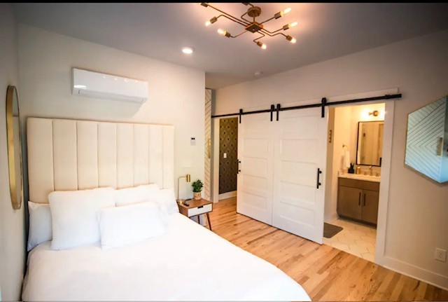 1701 Porter Road, Unit 8 Nashville, TN 37206 - Photo 5 of 17 a spacious bedroom with a large bed and a chandelier