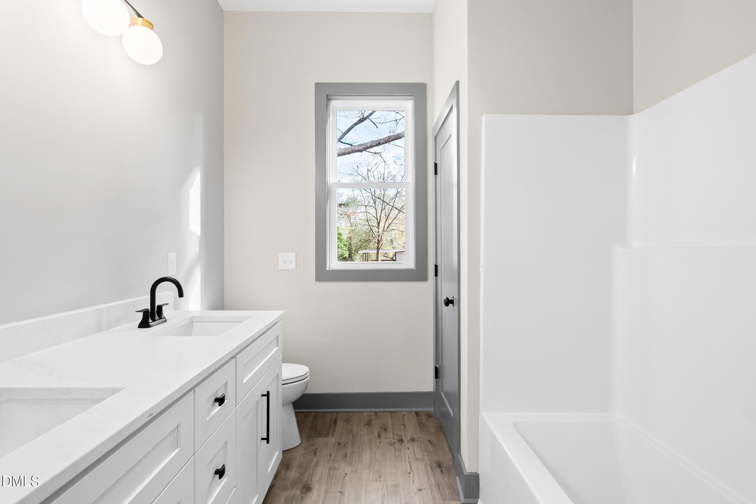 6731 Knightdale-Eagle Rock Road Wendell, NC 27591 - Photo 20 of 25 a bathroom with a sink a toilet and shower