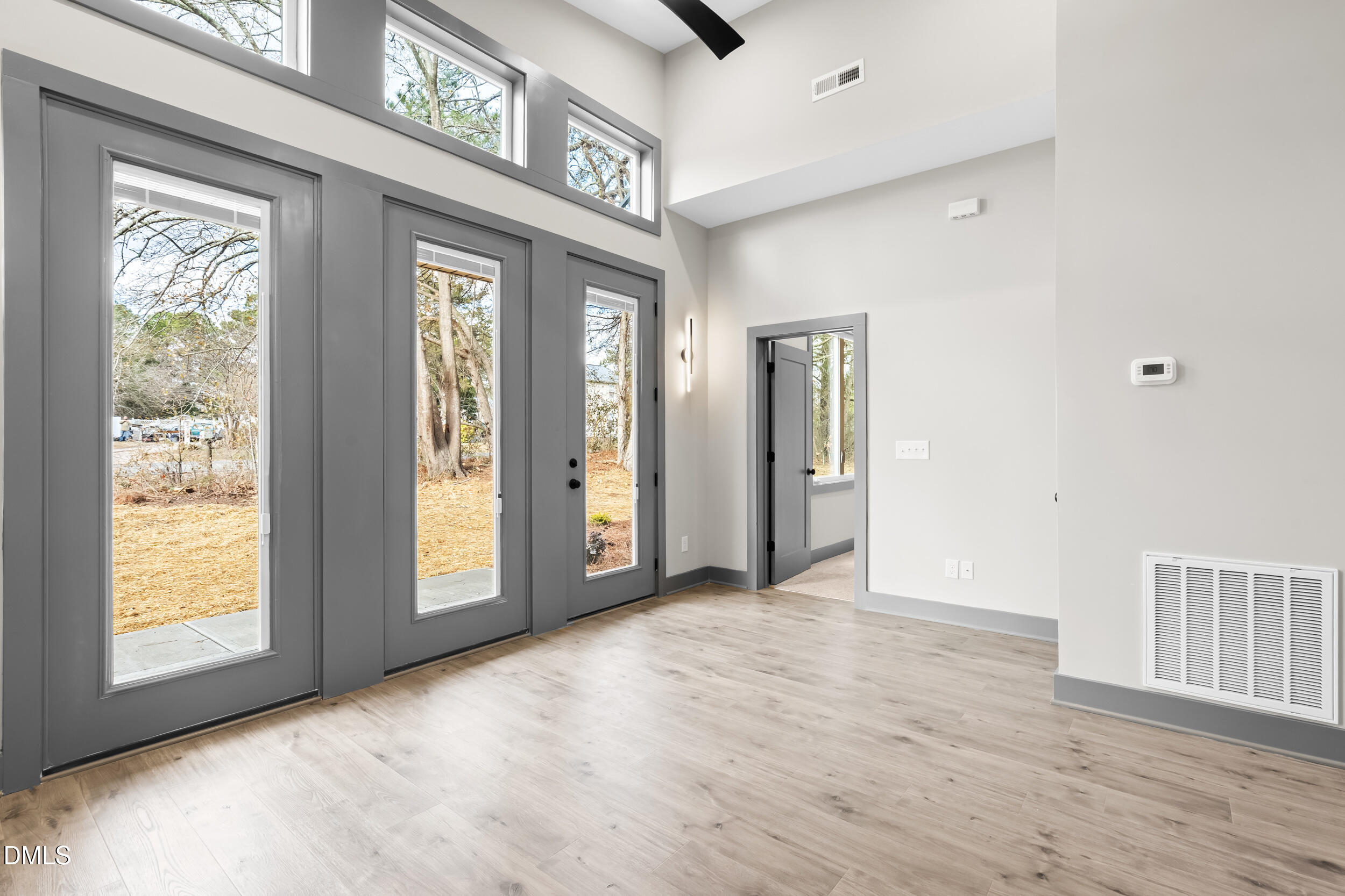 6731 Knightdale-Eagle Rock Road Wendell, NC 27591 - Photo 3 of 25 a view of an empty room with glass door and a window