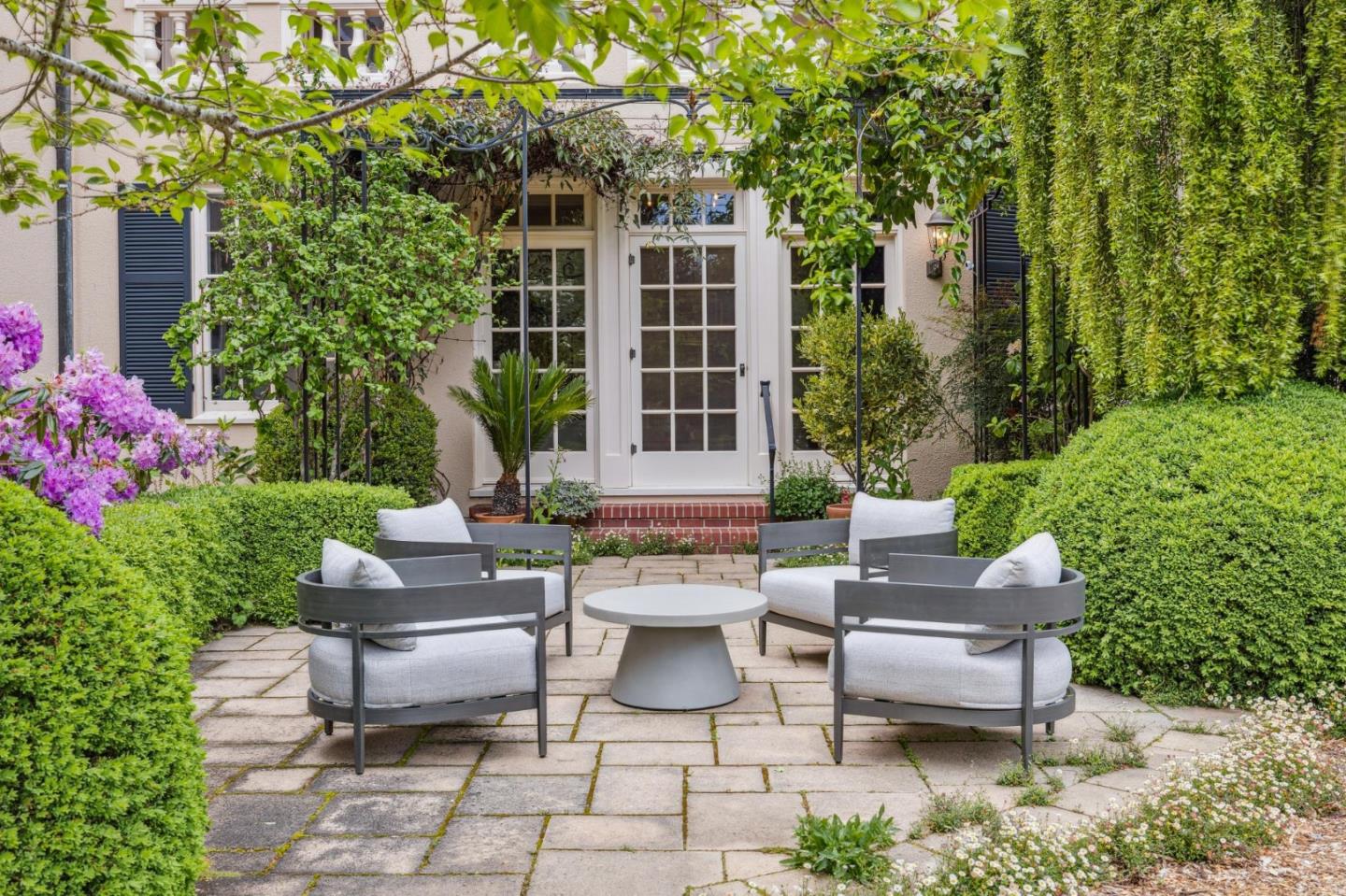 100 Cañada Road Woodside, CA 94062 - Photo 19 of 79 a view of a patio with couches table and chairs and potted plants