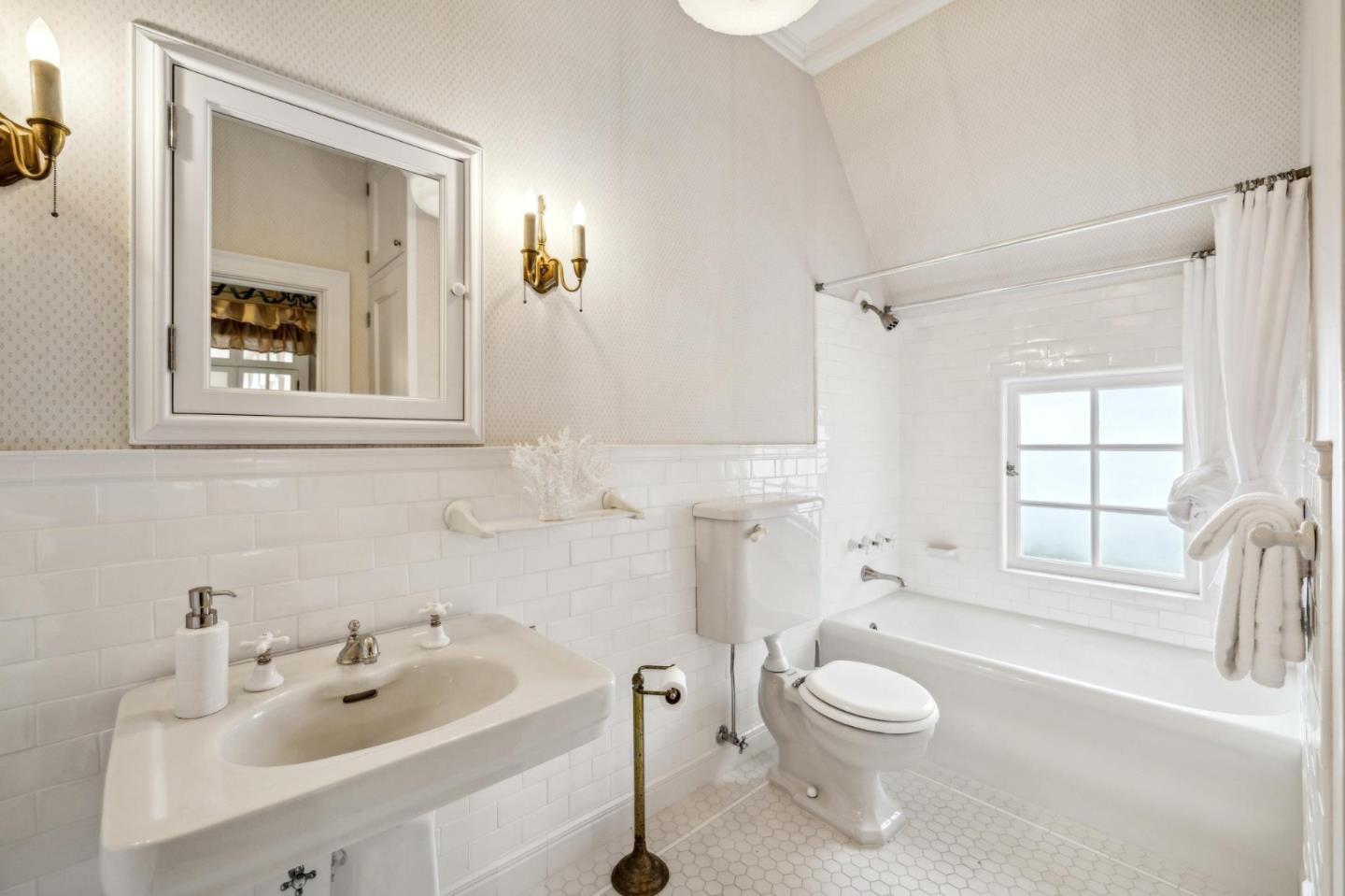 100 Cañada Road Woodside, CA 94062 - Photo 40 of 79 a bathroom with a toilet a sink a mirror a window and vanity