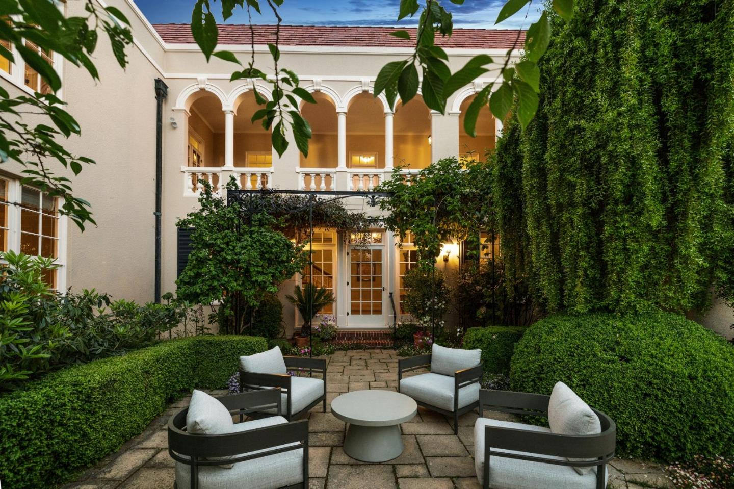 100 Cañada Road Woodside, CA 94062 - Photo 72 of 79 a view of a patio with couches table and chairs and garden