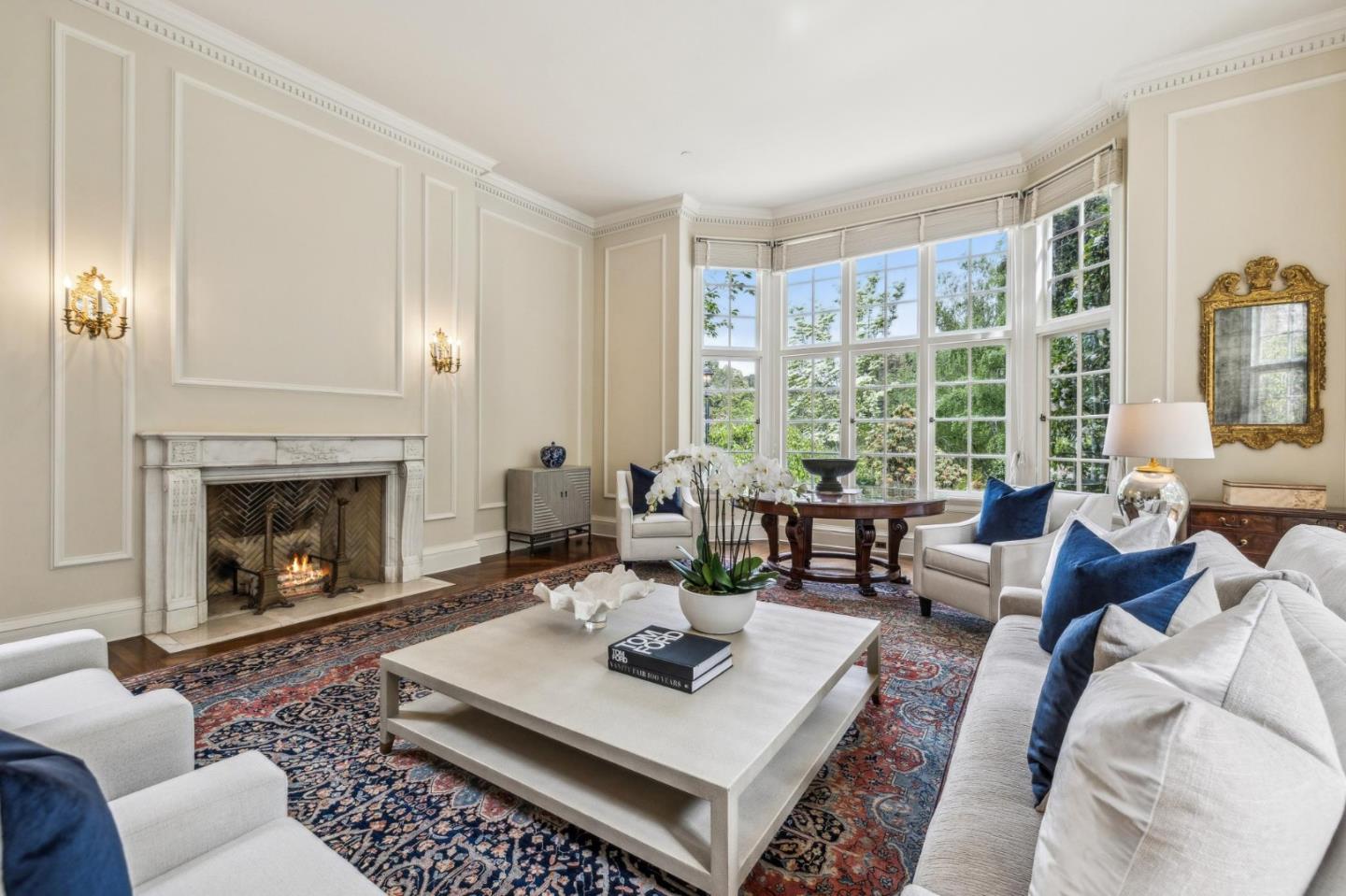 100 Cañada Road Woodside, CA 94062 - Photo 10 of 79 a living room with furniture a fireplace a large window and a flat screen tv