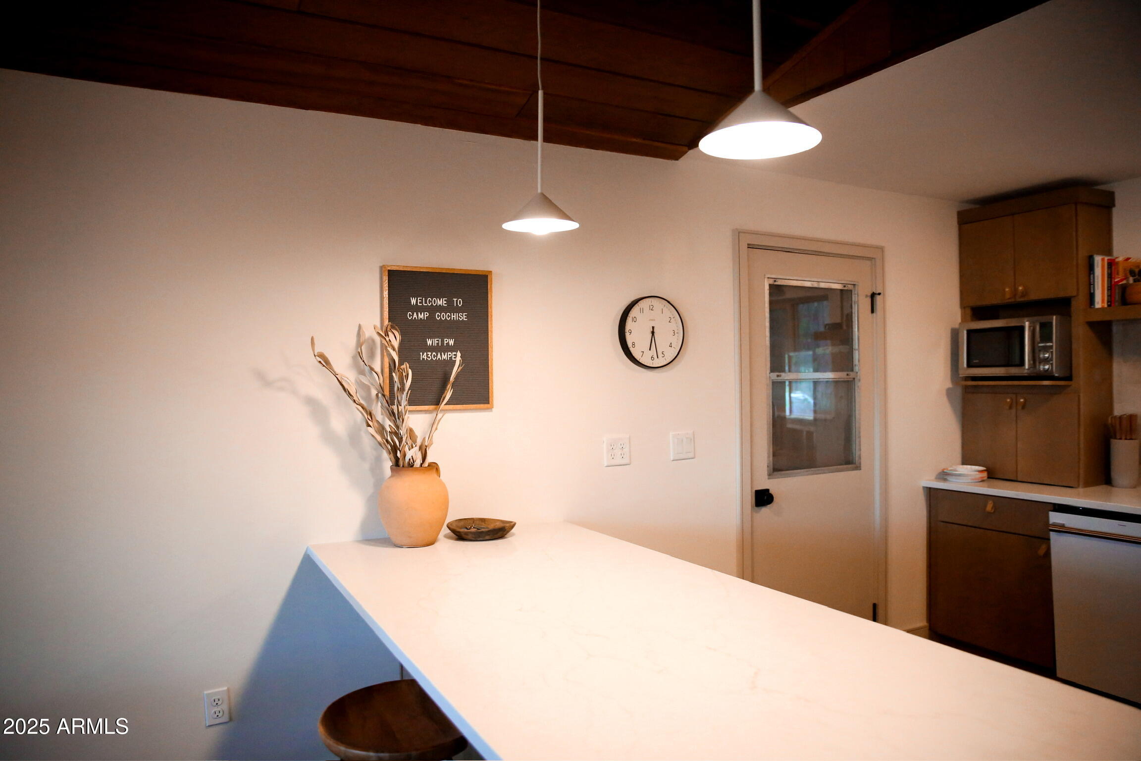 480 Cochise Road Munds Park, AZ 86017 - Photo 17 of 62 a bedroom with a bed and a chandelier