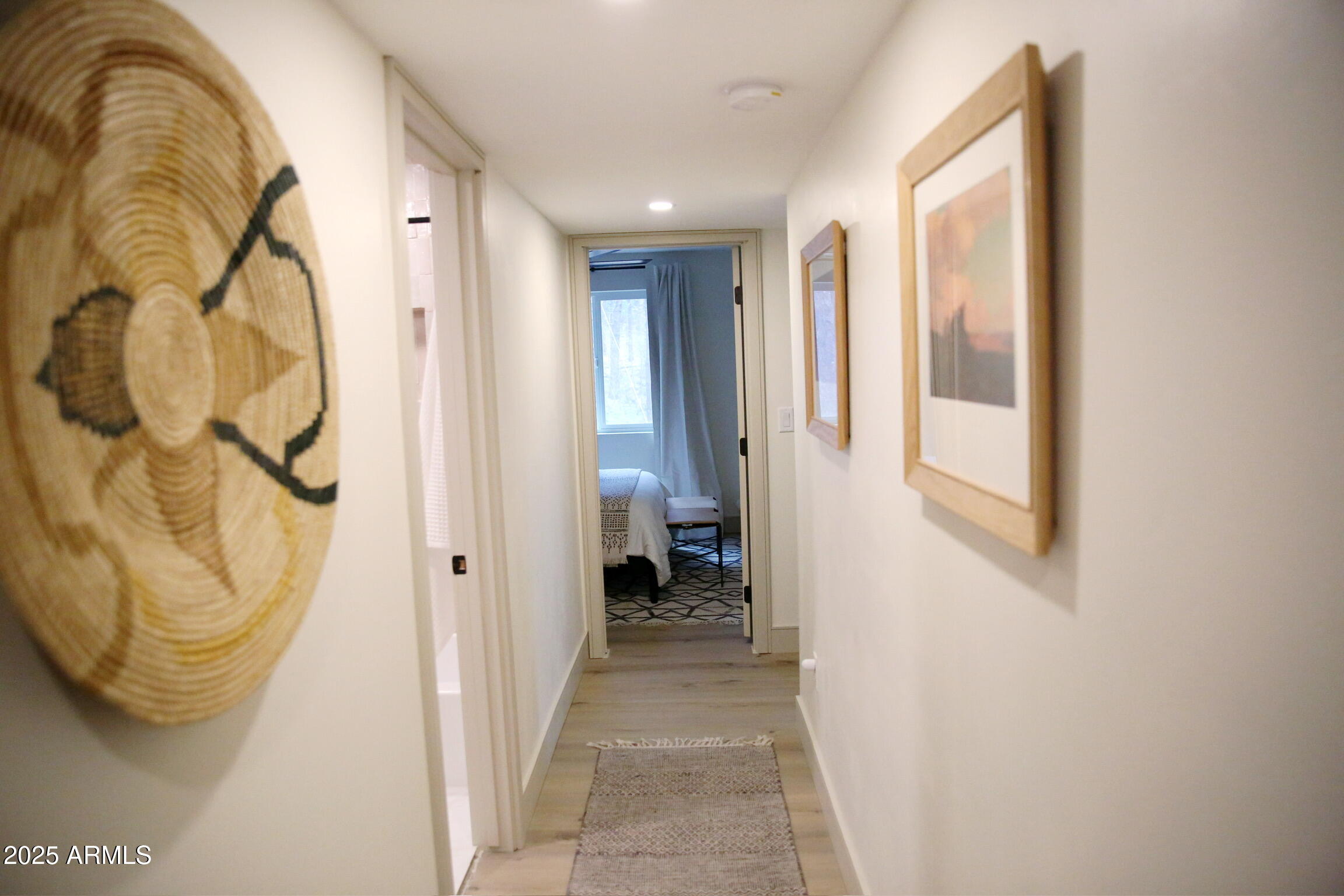 480 Cochise Road Munds Park, AZ 86017 - Photo 37 of 62 a view of a hallway with wooden floor and a bathroom