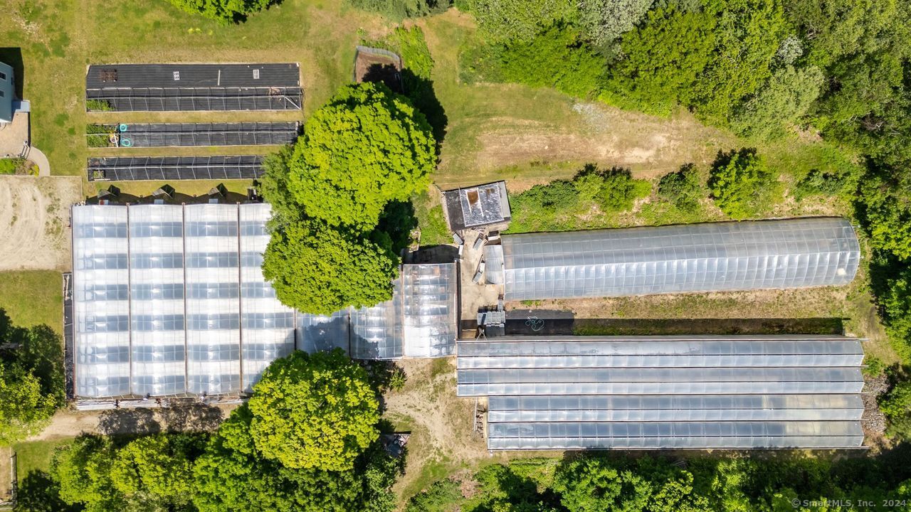 63 Willimantic Road Chaplin, CT 06235 - Photo 1 of 1 a view of a back yard of a house with a garden