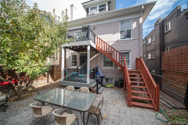 a view of a house with backyard and sitting area