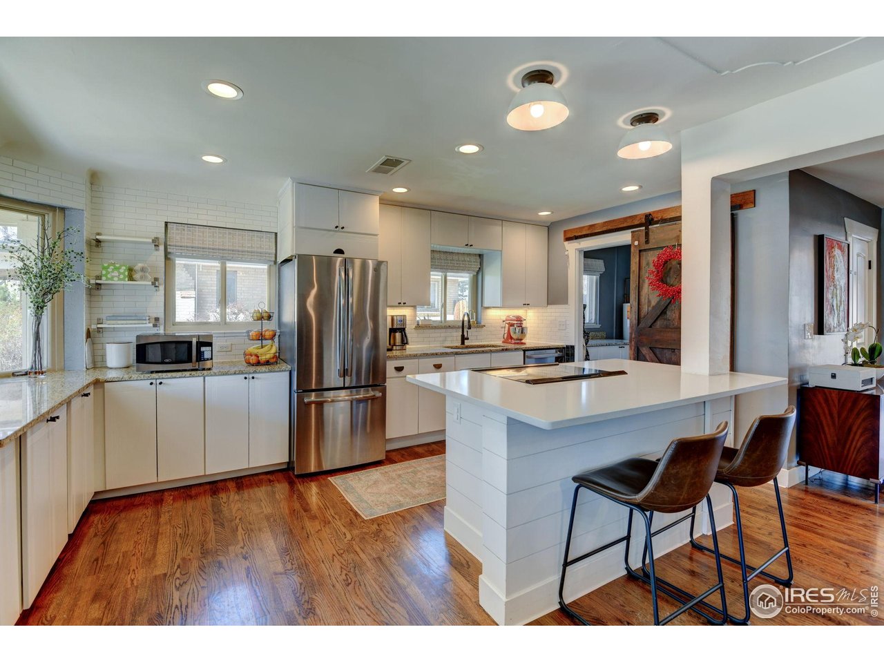 1150 Eudora Street Denver, CO 80220 - Photo 11 of 39 a kitchen with stainless steel appliances a refrigerator and a stove top oven