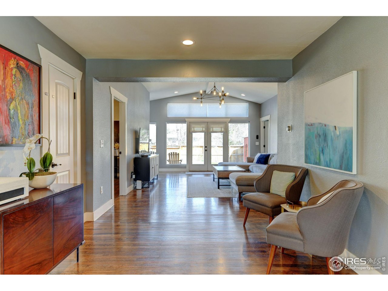 1150 Eudora Street Denver, CO 80220 - Photo 15 of 39 a living room with furniture and a chandelier