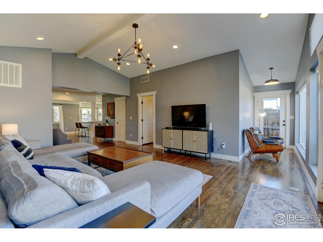 1150 Eudora Street Denver, CO 80220 - Photo 24 of 39 a living room with furniture and a flat screen tv
